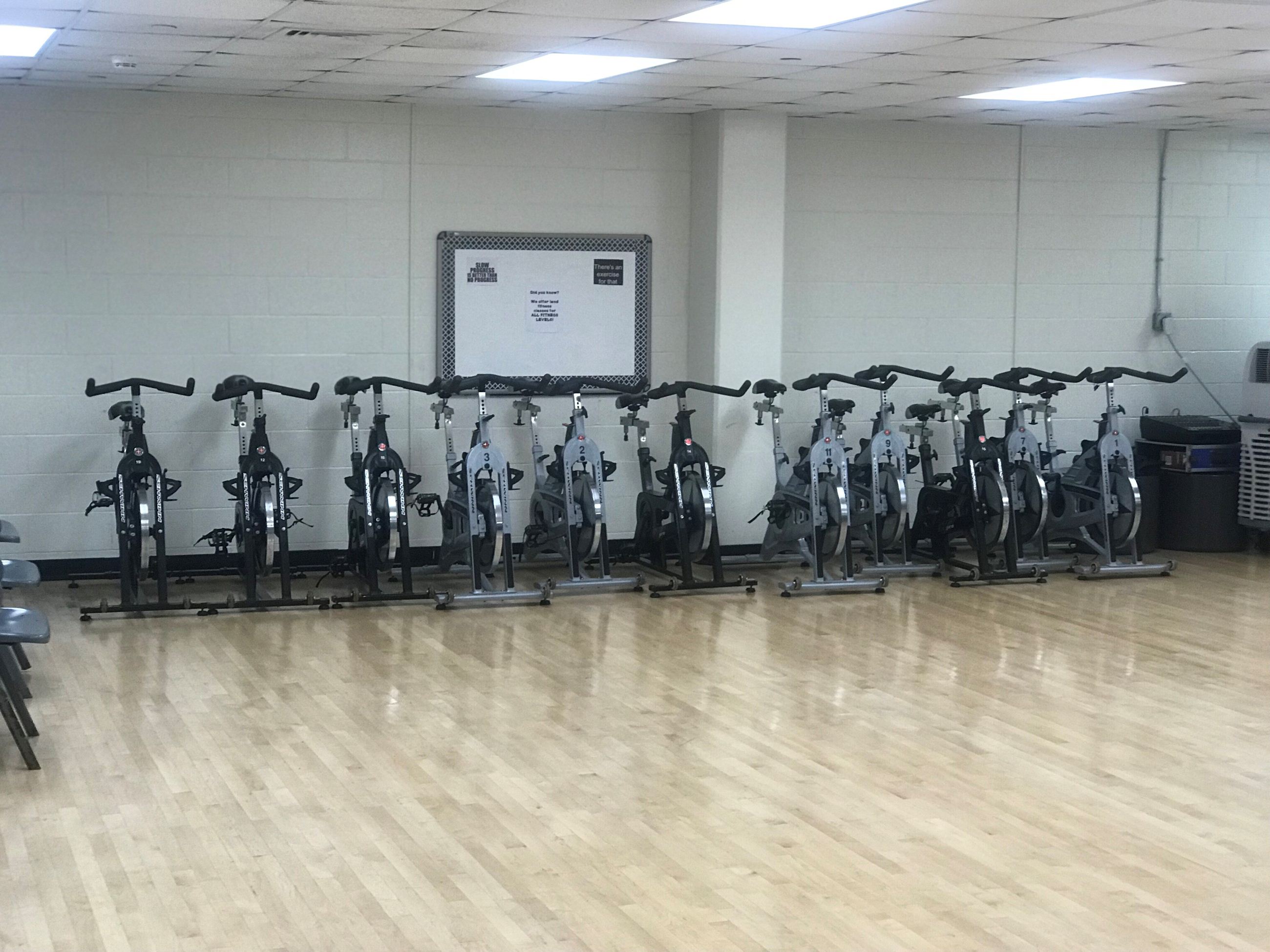 Stationary bikes along a wall